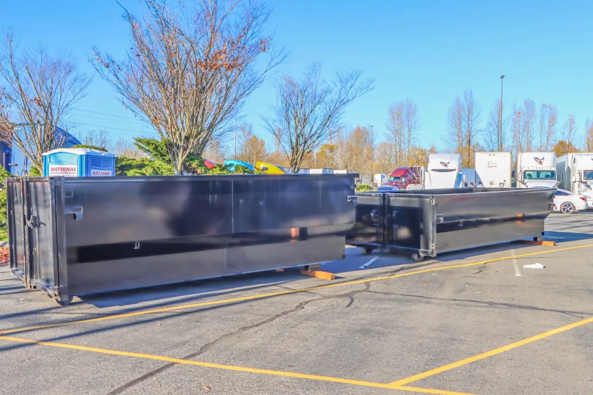 Professional dumpster rental service with roll-off container on residential driveway in Laplace